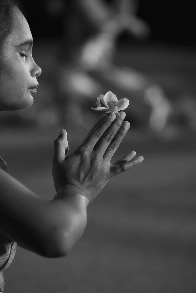 Praying, a Balinese girl doing her daily praying activity
